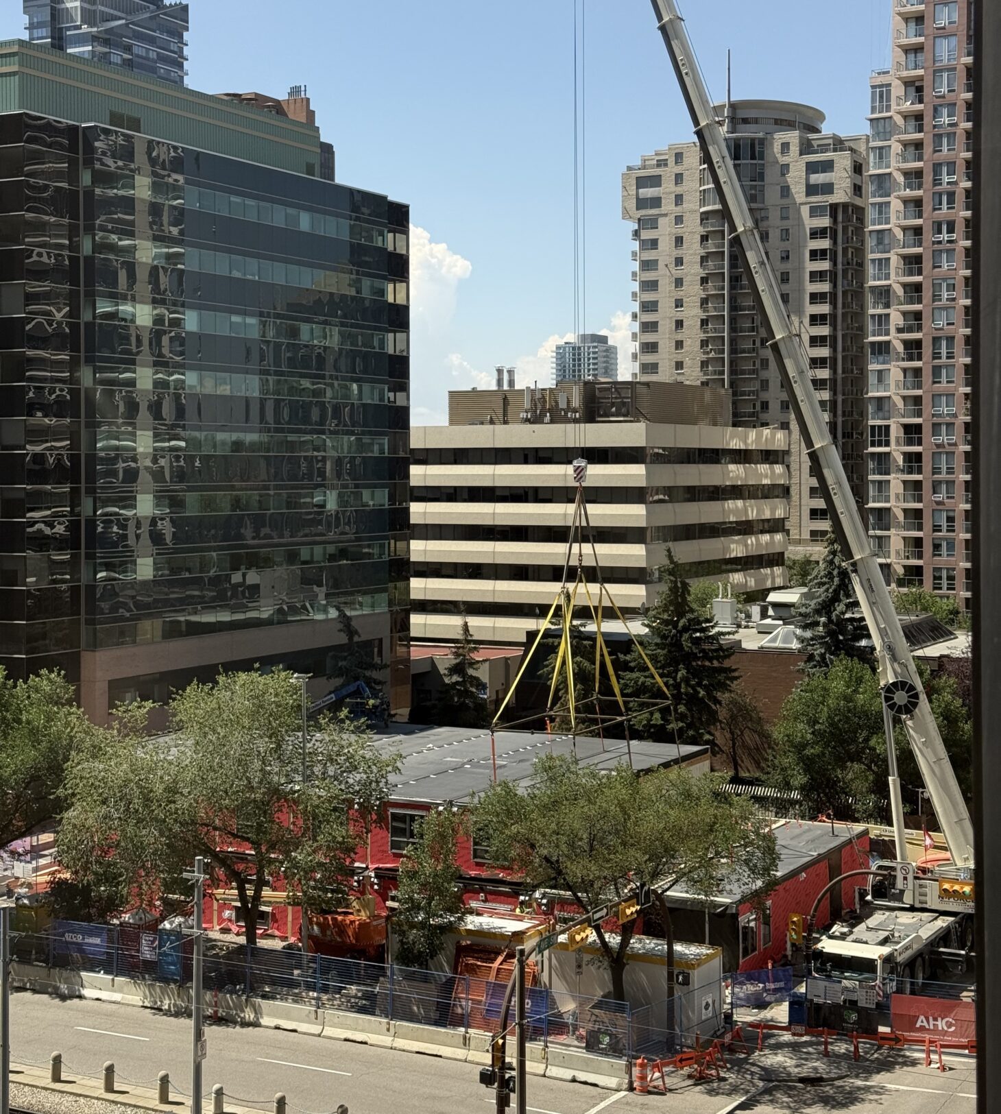building under construction with cranes Attainable Homes Calgary